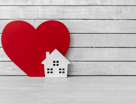 Home Shaped with Red Heart Shaped on white wood over white wood background